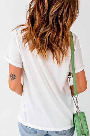 White graphic tee with rolled sleeves and an eye tattoo on the arm.