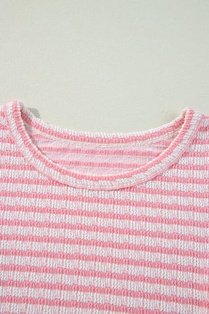 Textured stripe blouse in blush pink with a round neckline.