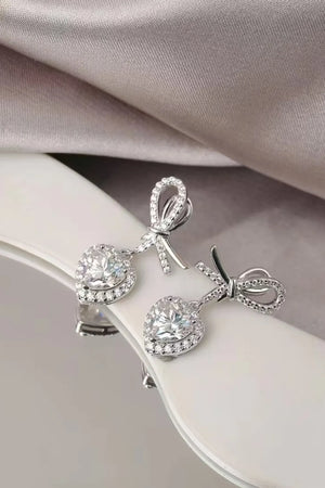 Silver moissanite heart drop earrings with bow detail, sterling silver