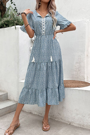 Light blue floral midi dress with tiered skirt, tassel details, and lace trim neckline.