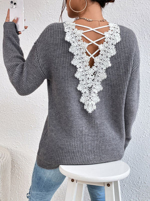 Gray ribbed knit sweater with white lace back detail and criss-cross straps.