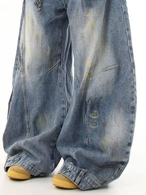 Washed blue wide-leg jeans with pocket detail and distressed accents.