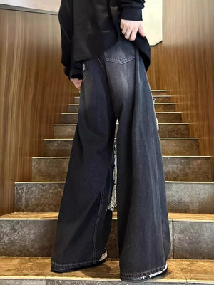 Relaxed fit dark wash denim jeans with distressed details and wide legs.