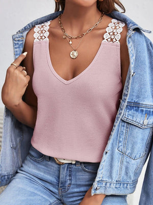 Pink waffle knit tank top with white lace shoulder straps and V-neck