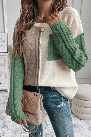 Colorblock cable knit sweater with a chest pocket in cream, tan, and gum leaf green.