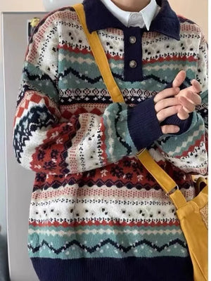 Geometric knit sweater with polo collar and button placket, featuring abstract patterns in navy, brown, and multicolor.