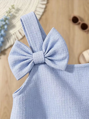 Sky blue baby dress with textured fabric and a large bowknot detail on the strap.