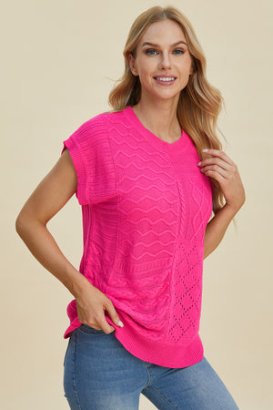 Hot pink knit patchwork top with cable and chevron textures and cap sleeves.