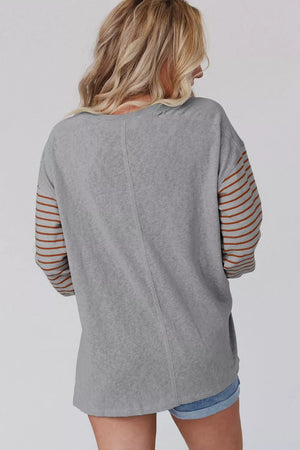 Gray maternity shirt with bishop sleeves featuring horizontal stripes