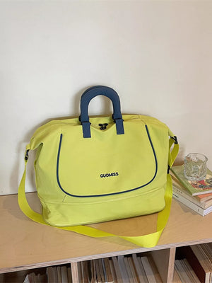 Chartreuse Oxford cloth duffle bag with navy trim and handles, "GUOMISS" logo.