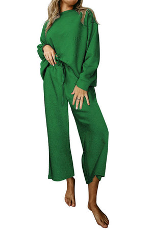 Green loungewear set with drop sleeves and wide-leg pants featuring a textured pattern.
