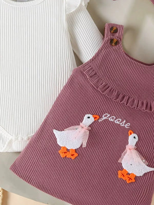 Plum purple corduroy dress with ruffle trim, goose applique, and white ribbed bodysuit with ruffle sleeves.