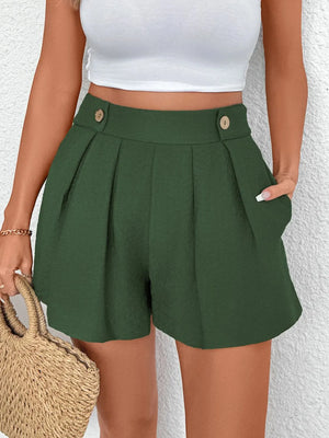 Dark green high-waisted pleated shorts with button detail and pockets.