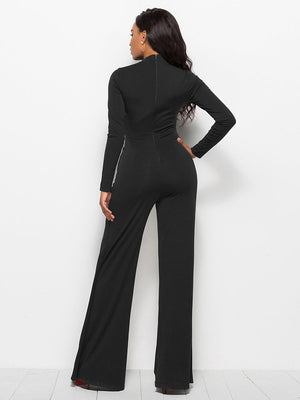 Black high-waisted palazzo jumpsuit with long sleeves and a slit front detail.