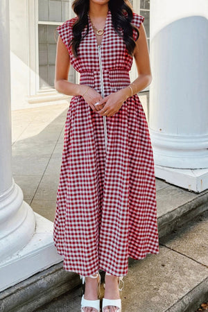 Gingham zip-front midi dress in red and white cotton with a cinched waist and cap sleeves.