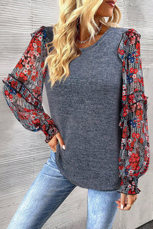Dark gray knit top with floral chiffon puff sleeves and ruffled cuffs.