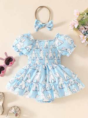 Sky blue baby dress with smocked bodice, puff sleeves, bunny print, and matching headband.