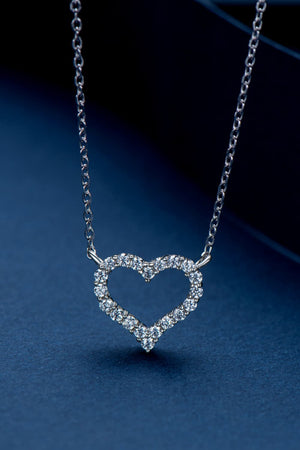 Silver heart pendant necklace with diamond embellishments on a delicate chain.