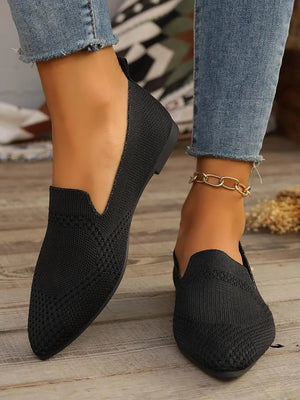 Black mesh pointed toe flats with a textured knit pattern.
