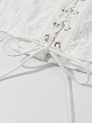 White eyelet tank top with corset lace-up detail and ruffle trim