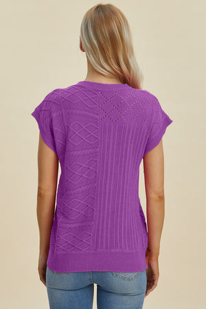 Purple knit patchwork top with cable and diamond stitch details, short sleeves.