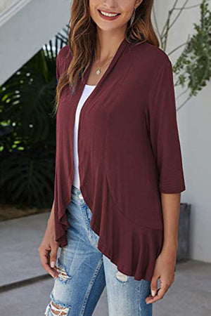 Burgundy cardigan with asymmetrical ruffle hem and 3/4 sleeves.