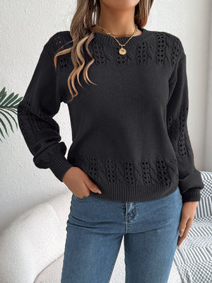 Black openwork knit sweater with cable detail on sleeves and hem
