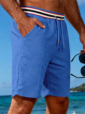 Blue textured chino shorts with drawstring and striped waistband detail.