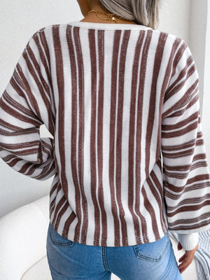 Striped knit cropped pullover sweater with a lace-up detail and long sleeves.