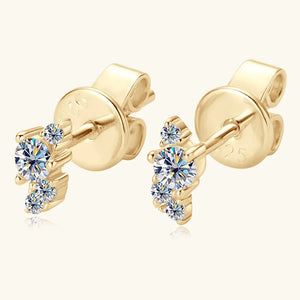 Gold celestial cluster diamond stud earrings with three clear stones.