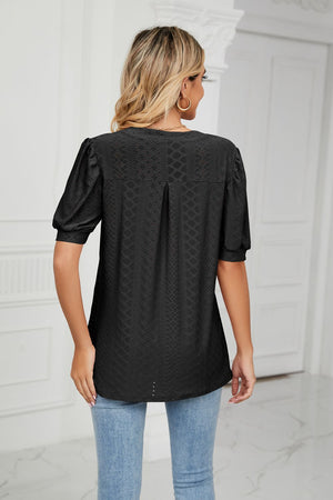 Black perforated puff sleeve blouse with keyhole detail and textured pattern