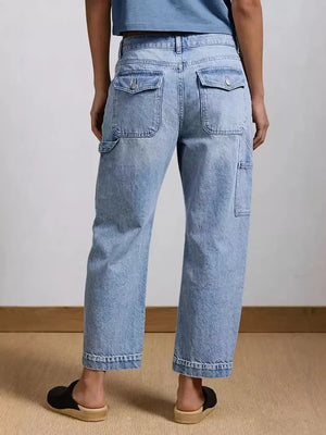 Light wash denim maternity jeans with wide legs, buttoned flap pockets, and utility details.