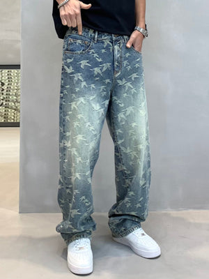 Loose-fit denim jeans with all-over bird print and vintage wash.