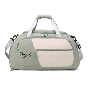 Colorblock travel duffel bag in Sage with a pale blush front panel and logo detail.