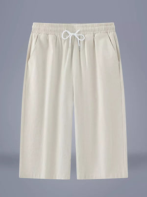 Relaxed ivory cropped sweatpants with drawstring waist and side pockets.