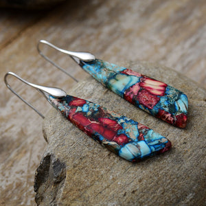 Marbled stone teardrop earrings in red and blue with silver hooks.