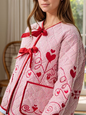 Red seersucker bow jacket with heart embroidery and tie closure.