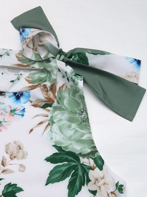Painterly floral bow-neck sleeveless top in Gum Leaf with a white base and green, blue, and tan flowers.