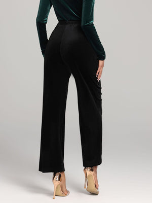 Black velvet palazzo trousers with a wide leg cut and elastic waistband.