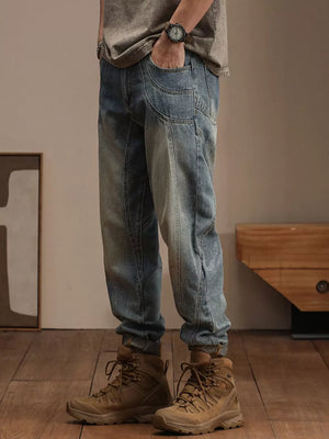 Relaxed fit vintage wash denim jeans with unique pocket details and a tapered leg.