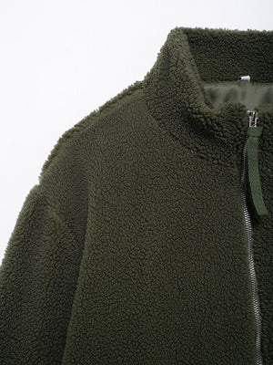 Olive green sherpa jacket with stand collar and zipper detail.