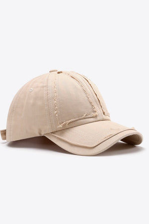 Camel raw edge denim baseball cap with distressed details.