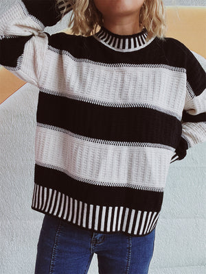 Textured stripe mock neck knit sweater in black and white with ribbed neckline and cuffs.