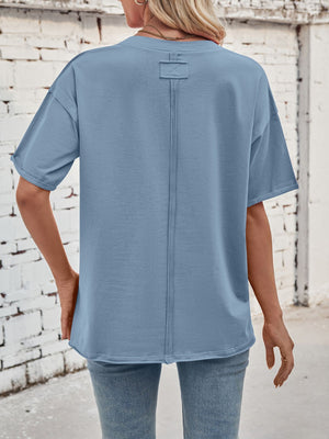 Oversized dusty blue cotton tee with seam detail on back and rolled sleeves.
