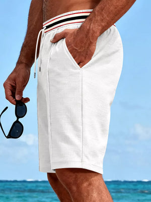 Textured white chino shorts with drawstring and striped waistband detail.
