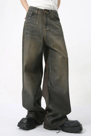 Faded oversized denim trousers in dark wash, featuring a relaxed fit and wide leg.