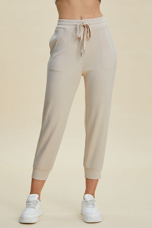 Beige joggers with drawstring waist and cuffed ankles