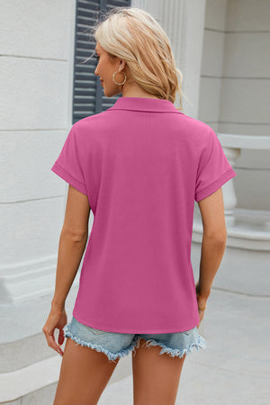 Textured hot pink polo top with cuffed short sleeves and a collar.