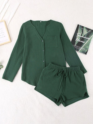 Textured cotton pajama set in dark green with button-up top and drawstring shorts.