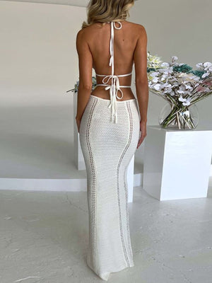 White backless knitted maxi dress with cutouts and halter neck.